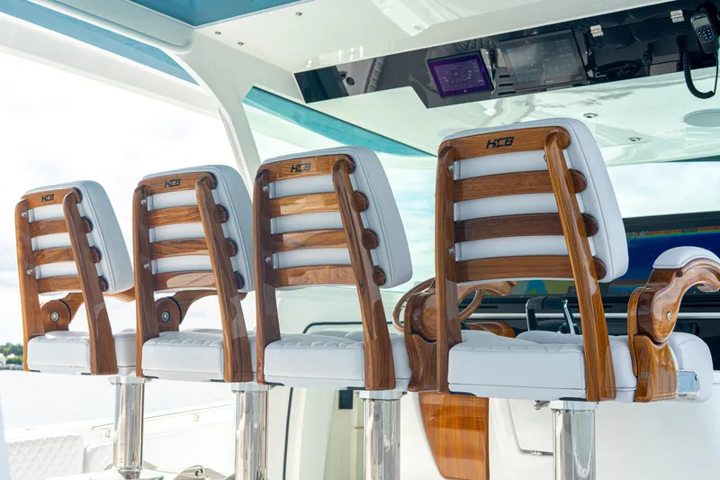Slide: The Image of Luxury seating on 2026 HCB 56 Suenos GIX boat, featuring elegant wooden and white leather design. - 31