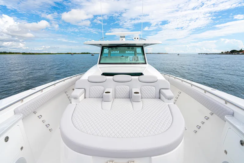 Slide: The Image of 2026 HCB 56 Suenos GIX luxury boat with plush seating on open water. - 36