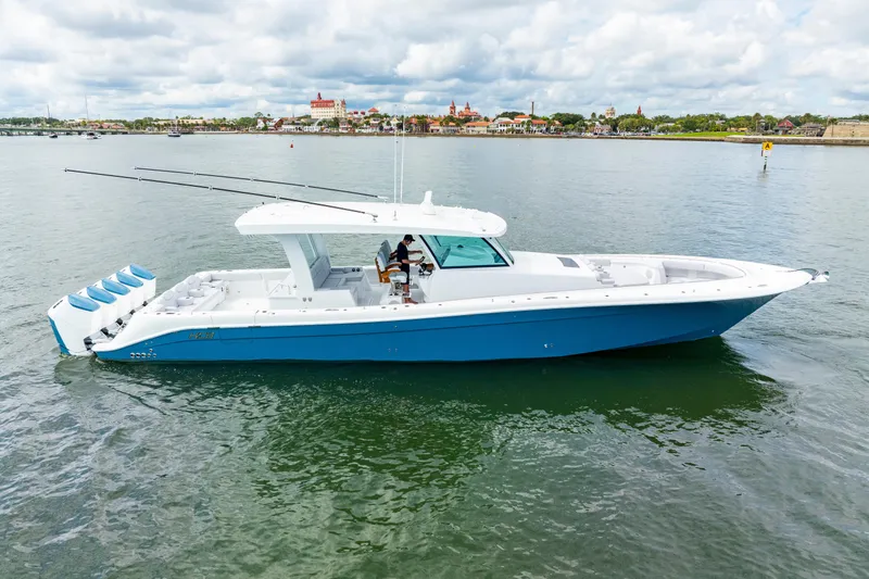 Slide: The Image of 2026 HCB 56 Suenos GIX boat on calm water, featuring sleek design and multiple engines. - 5