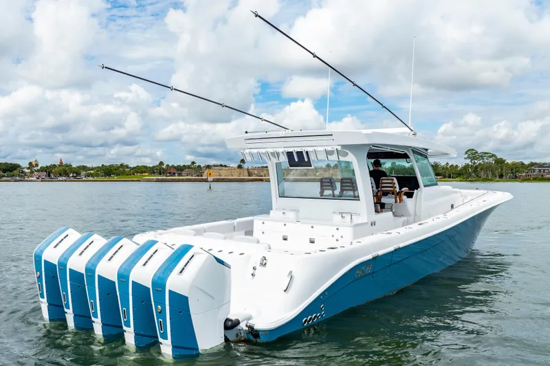 Slide: The Image of 2026 HCB 56 Suenos GIX boat with multiple engines on a calm waterway. - 7