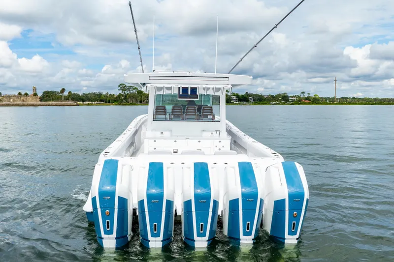 Slide: The Image of 2026 HCB 56 Suenos GIX boat with multiple engines on calm water. - 8