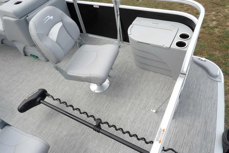 Slide: The Image of 2023 Bennington 20 SVF pontoon boat interior with gray seating and storage console. - 10