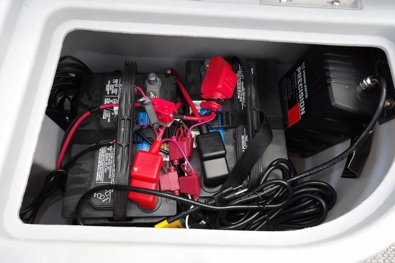 Slide: The Image of 2023 Bennington 20 SVF battery compartment with wiring and charger setup. - 14