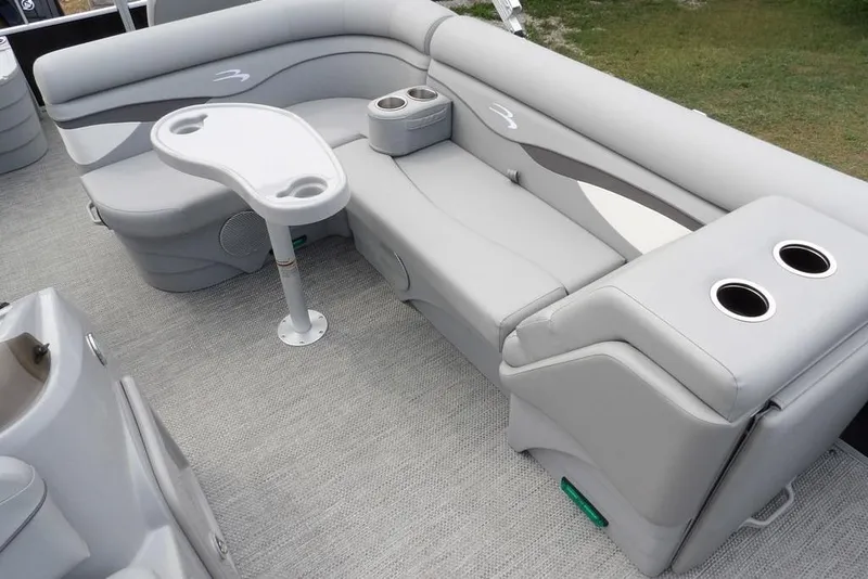 Slide: The Image of 2023 Bennington 20 SVF pontoon boat interior with gray seating and cup holders. - 18