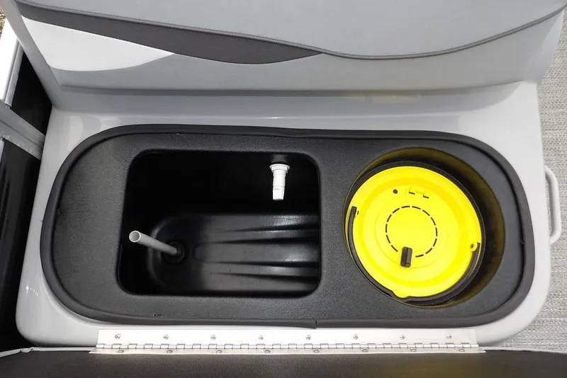 Slide: The Image of 2023 Bennington 20 SVF boat storage compartment with yellow lid and drainage pipe. - 23