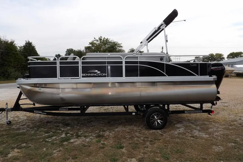 Slide: The Image of 2023 Bennington 20 SVF pontoon boat on trailer, parked outdoors. - 3