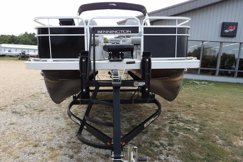 Slide: The Image of 2023 Bennington 20 SVF pontoon boat on trailer, parked outside a building. - 6