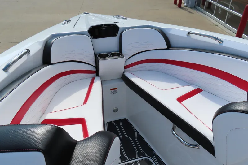 Slide: The Image of 2022 Sunsation 32CCX boat interior with white and red seating, cup holders, and sleek design. - 11