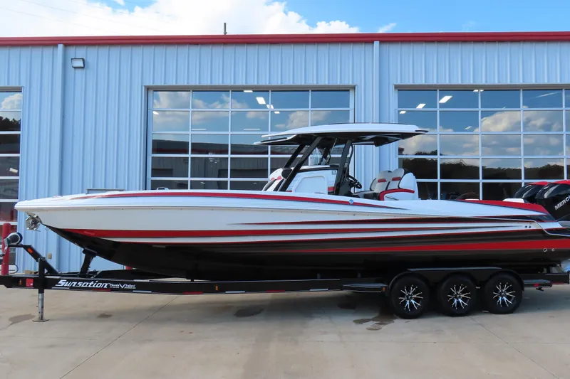 Slide: The Image of 2022 Sunsation 32CCX boat on trailer, parked outside a modern building. - 3