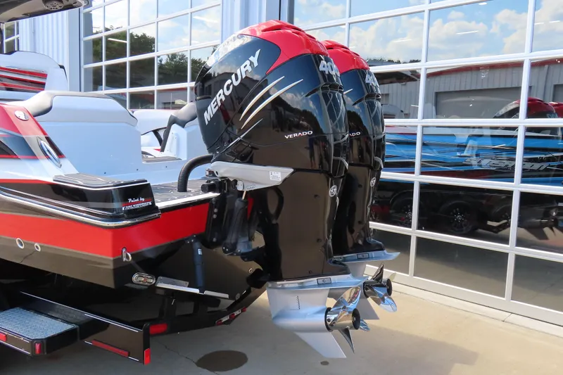 Slide: The Image of 2022 Sunsation 32CCX boat with dual Mercury Verado 400 engines, docked near glass building. - 6