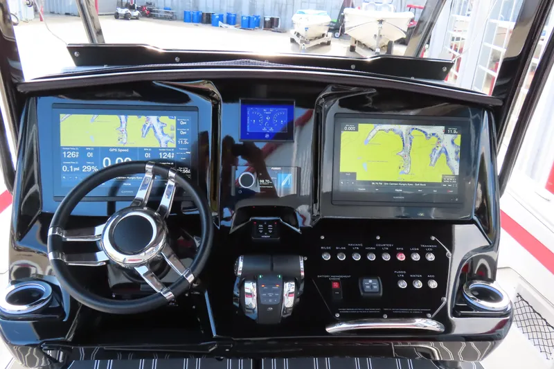 Slide: The Image of 2022 Sunsation 32CCX boat dashboard with dual navigation screens and modern controls. - 9