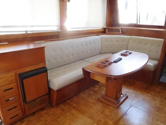 Slide: The Image of Interior of 1999 Grand Banks 42 Motoryacht with wooden furnishings and cushioned seating. - 36