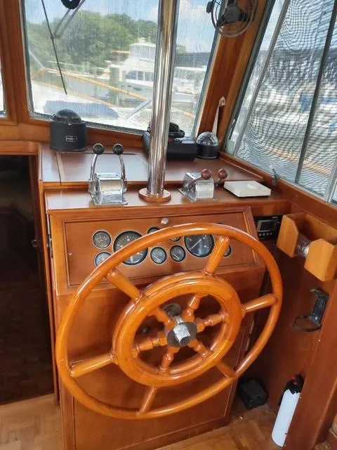 Slide: The Image of Helm of 1999 Grand Banks 42 Motoryacht with wooden wheel and control panel. - 45