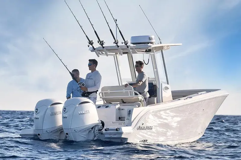 Slide: The Image of 2026 Sailfish 252 CC boat on trailer, parked outdoors under a clear sky. - 1