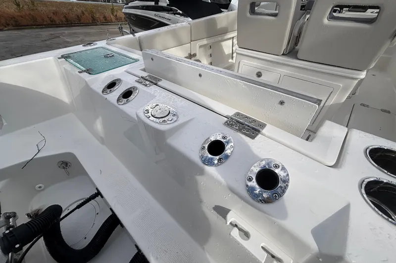 Slide: The Image of 2026 Sailfish 252 CC boat interior with rod holders and seating area. - 14