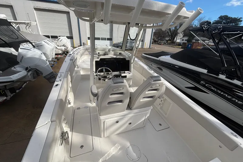 Slide: The Image of 2026 Sailfish 252 CC boat interior with dual seats and steering console. - 15