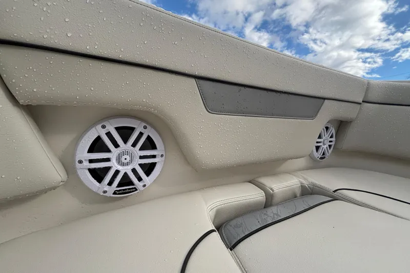 Slide: The Image of Wet interior speakers on 2026 Sailfish 252 CC boat under cloudy sky. - 20