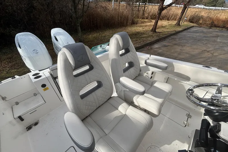 Slide: The Image of 2026 Sailfish 252 CC boat interior with dual seats and steering wheel. - 21