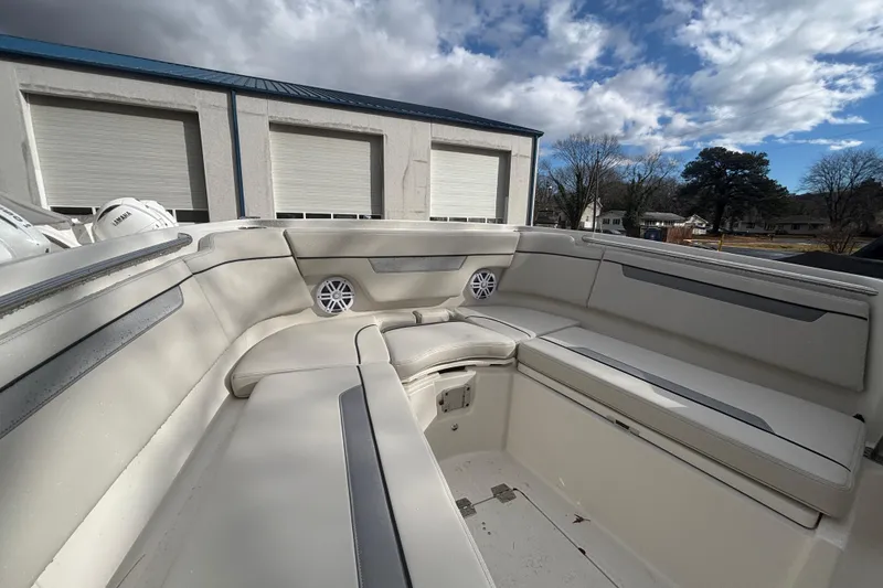 Slide: The Image of 2026 Sailfish 252 CC boat interior with cushioned seating and speakers. - 23