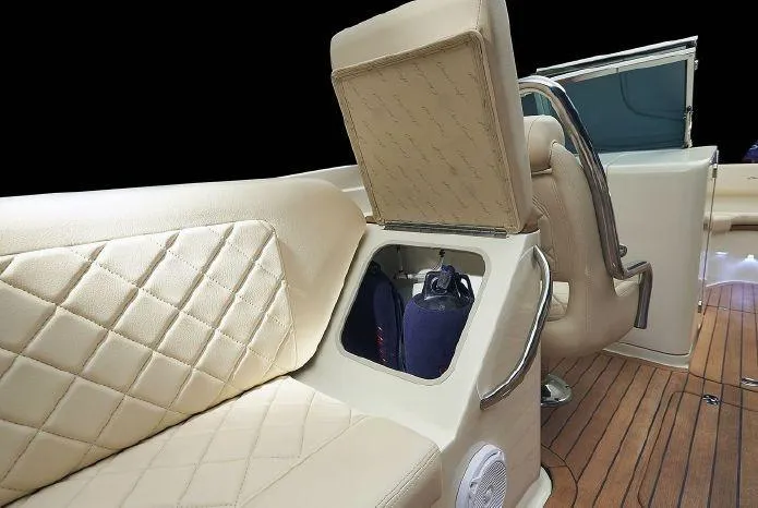 Slide: The Image of 2024 Chris-Craft Launch 27 interior with beige diamond-stitched seating and storage compartment. - 7