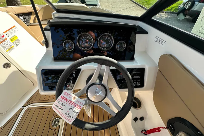 Slide: The Image of 2024 Sea Ray SPX 210 boat dashboard with steering wheel and gauges. - 10