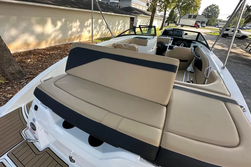 Slide: The Image of 2024 Sea Ray SPX 210 boat interior with beige seating and modern design. - 16