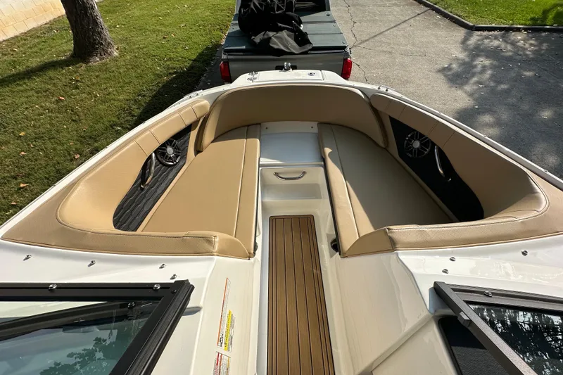 Slide: The Image of 2024 Sea Ray SPX 210 boat interior with tan seating and wood accents. - 3