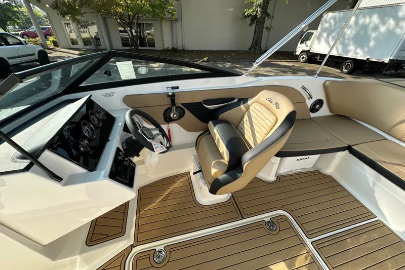 Slide: The Image of 2024 Sea Ray SPX 210 boat interior with tan seating and modern dashboard. - 4