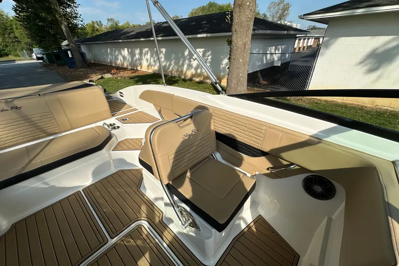 Slide: The Image of 2024 Sea Ray SPX 210 boat interior with tan seating and wood-style flooring. - 5