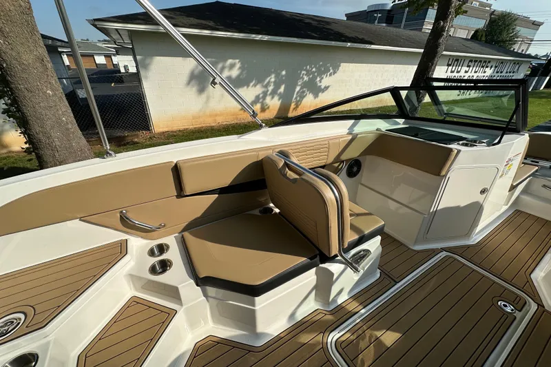 Slide: The Image of 2024 Sea Ray SPX 210 boat interior with tan seating and wood-style flooring. - 6