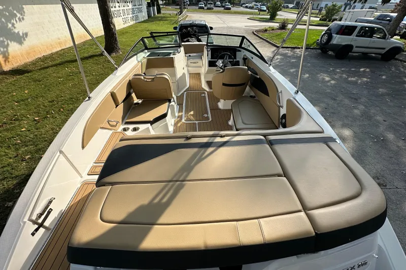 Slide: The Image of 2024 Sea Ray SPX 210 boat interior with tan seating and sleek design. - 8