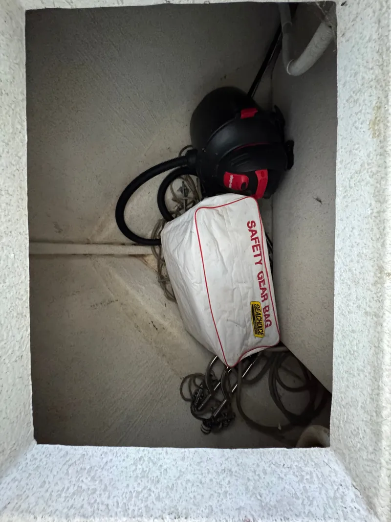 Slide: The Image of Safety gear bag and helmet in storage compartment of 1994 Gibson model 44. - 39