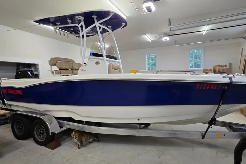 Slide: The Image of 2019 NauticStar 231 Hybrid boat on trailer in garage setting. - 12