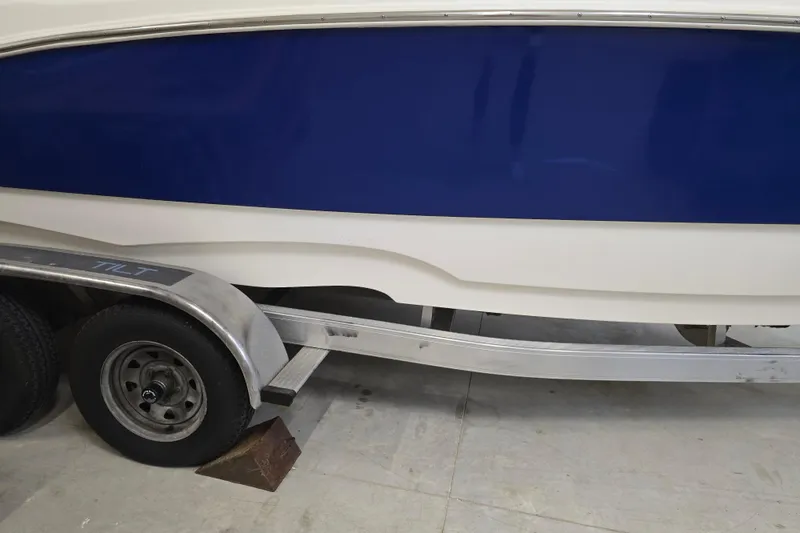 Slide: The Image of 2019 NauticStar 231 Hybrid boat on trailer, blue and white hull. - 14