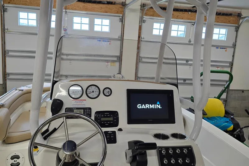 Slide: The Image of 2019 NauticStar 231 Hybrid boat dashboard with Garmin display in a garage. - 20