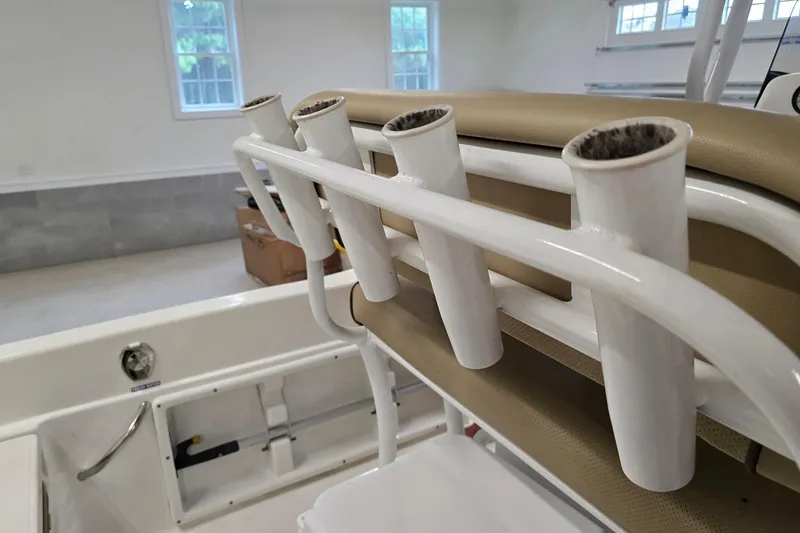 Slide: The Image of 2019 NauticStar 231 Hybrid boat rod holders in a bright interior setting. - 23