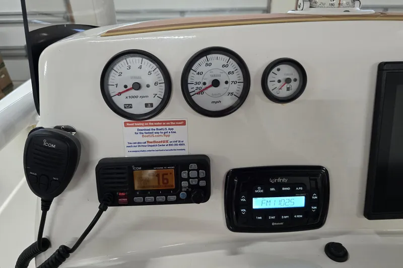 Slide: The Image of Dashboard of 2019 NauticStar 231 Hybrid boat with gauges and communication devices. - 30