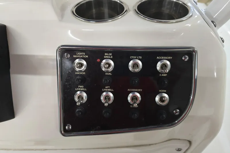 Slide: The Image of Control panel of a 2019 NauticStar 231 Hybrid boat with various switches. - 31