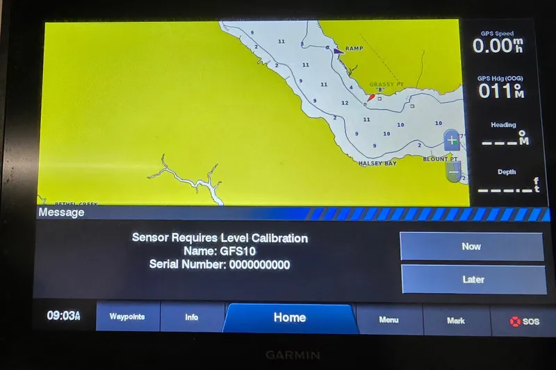 Slide: The Image of Garmin GPS display on 2019 NauticStar 231 Hybrid, showing map and calibration message. - 32