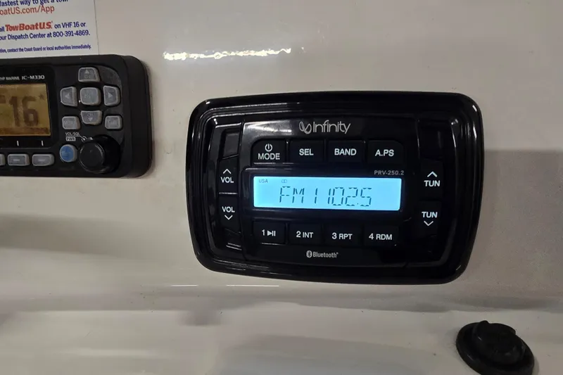 Slide: The Image of Infinity marine radio display on 2019 NauticStar 231 Hybrid boat dashboard. - 33