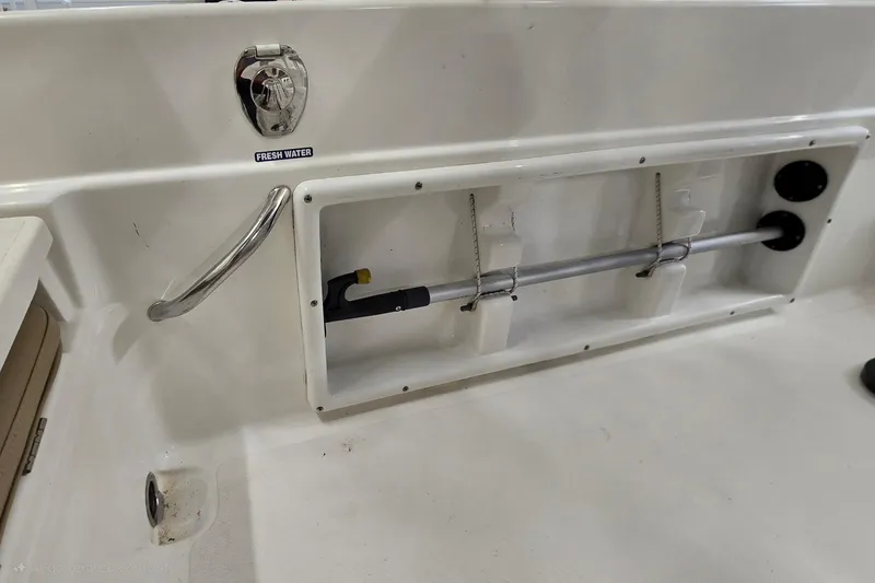 Slide: The Image of 2019 NauticStar 231 Hybrid boat interior with fresh water access and storage compartment. - 37