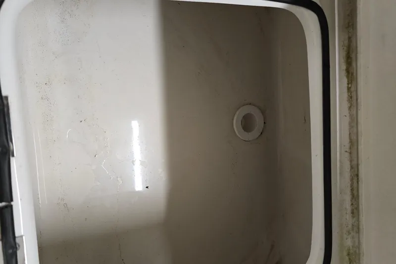 Slide: The Image of 2019 NauticStar 231 Hybrid boat storage compartment, showing interior details. - 38