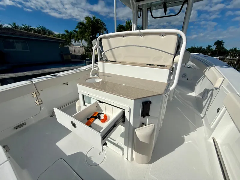 Slide: The Image of 2024 Sea Hunt Ultra 275 SE boat interior with open storage drawer and seating. - 11