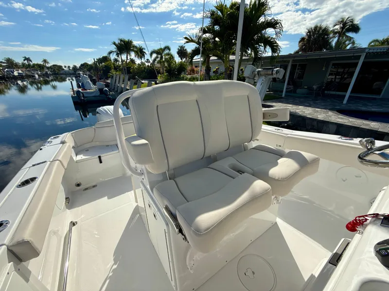 Slide: The Image of 2024 Sea Hunt Ultra 275 SE boat interior with comfortable seating and scenic waterfront view. - 24