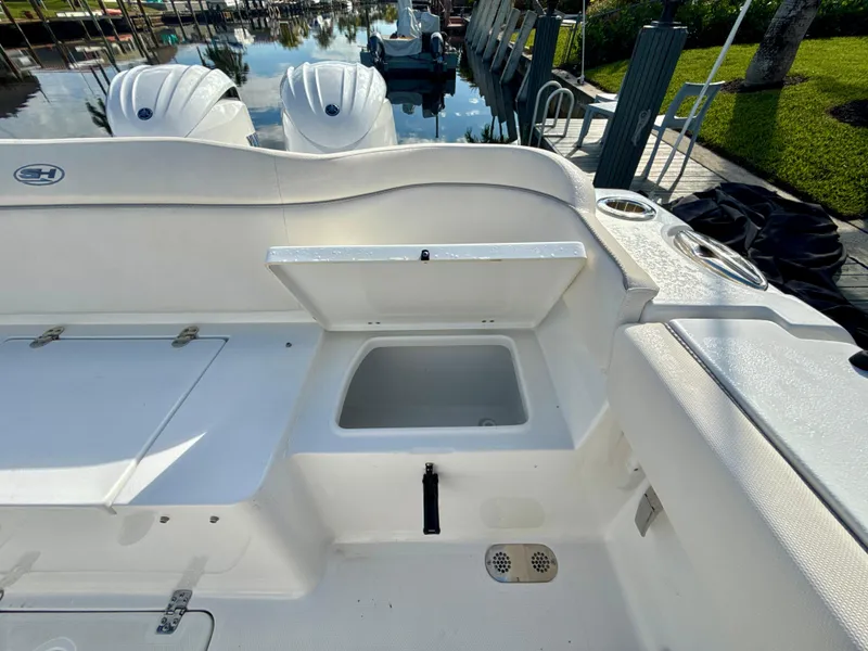 Slide: The Image of 2024 Sea Hunt Ultra 275 SE boat interior with open storage compartment. - 9