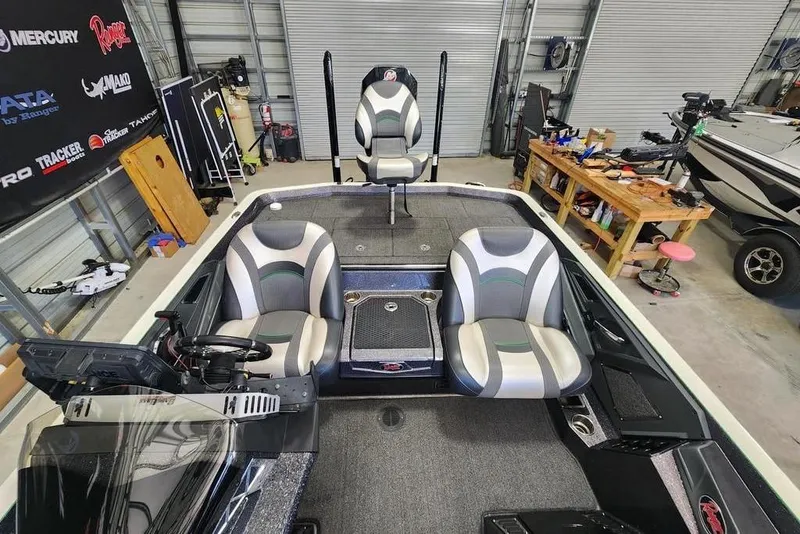 Slide: The Image of 2020 Ranger Z520L boat interior with three seats in a garage setting. - 4