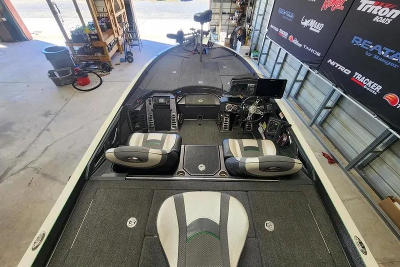 Slide: The Image of 2020 Ranger Z520L bass boat interior with seating and control panel in a garage setting. - 7