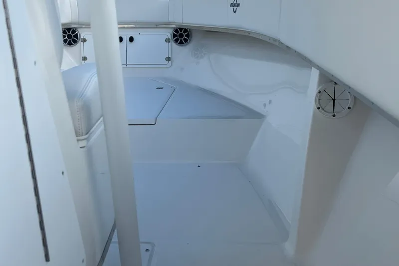 Slide: The Image of 2002 Fountain 29 Center Console interior with white seating and storage compartments. - 11