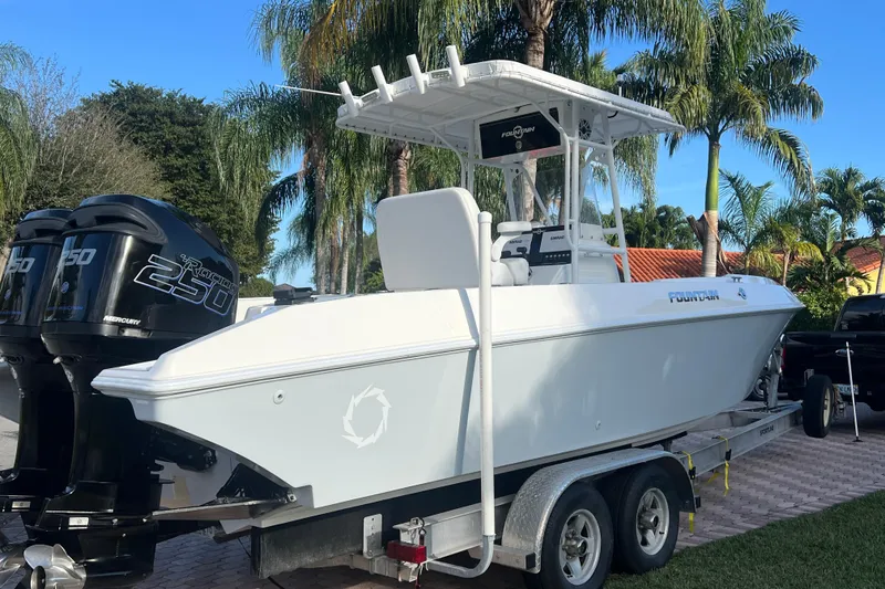 Slide: The Image of 2002 Fountain 29 Center Console boat on trailer with twin Mercury 250 engines. - 3