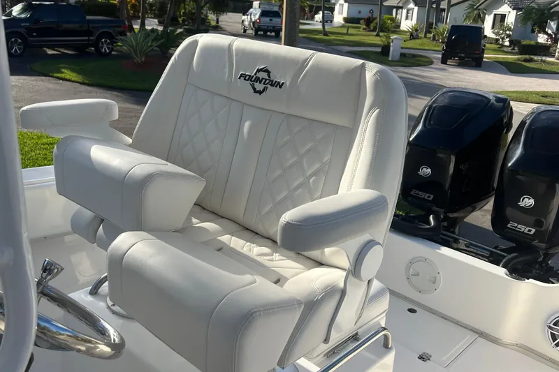 Slide: The Image of Luxurious seating on a 2002 Fountain 29 Center Console boat with dual Mercury engines. - 7